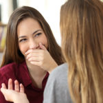 woman hides smile